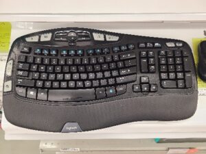 A keyboard on a desk Description automatically generated with medium confidence