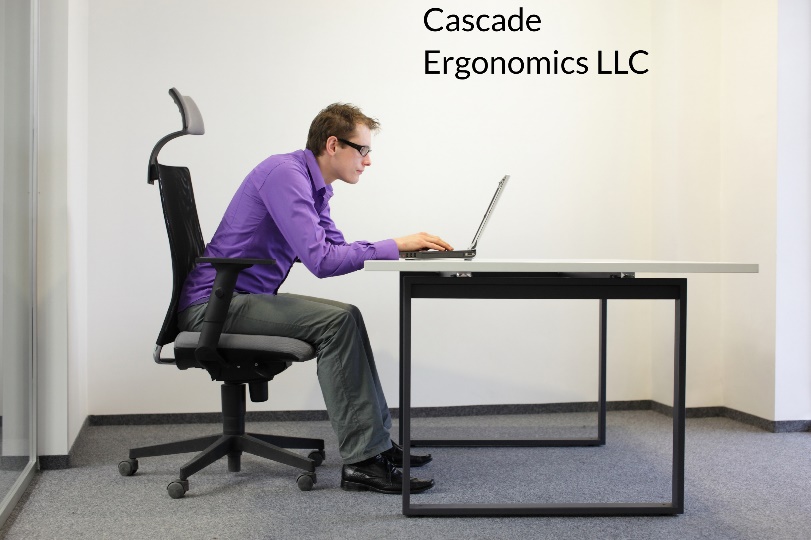 A person sitting at a desk Description automatically generated with medium confidence