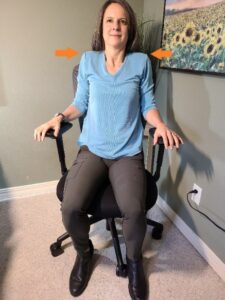 A person sitting in a chair Description automatically generated