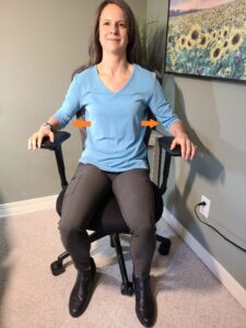 A person sitting in a chair Description automatically generated